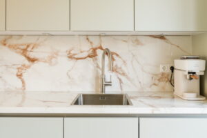 Keukentrends 2026 gecombineerd: Mint zacht groene keukenfronten, keramieken marmer aanrechtblad en achterwand Evora Ceramics Spectacle, RVS Quooker Flex en RVS spoelbak & koffie corner